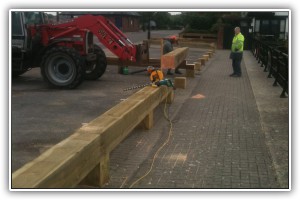Heavy timbers are manouvered into position