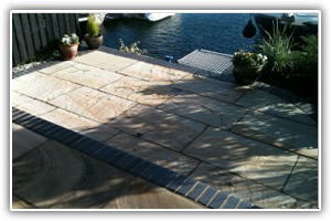 Multi level indian sandstone paving leading to waters edge at Hythe Marina, Hampshire